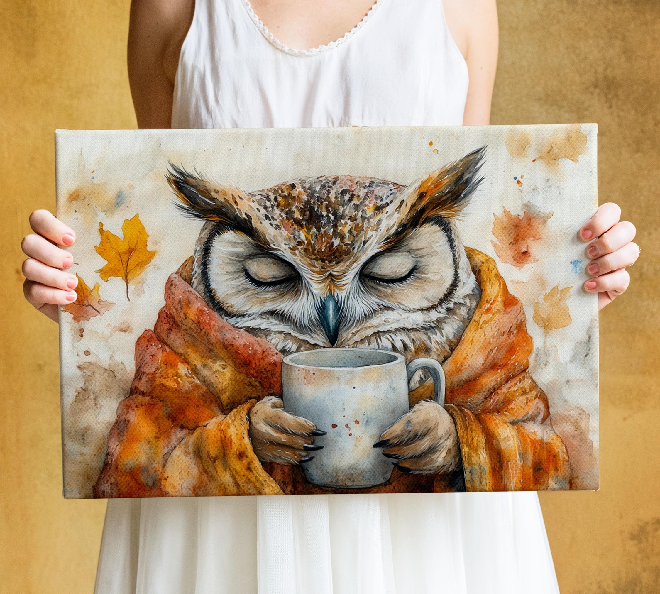A woman holds a painting of an owl wearing a red and orange robe and holding a mug, with autumn leaves in the background.