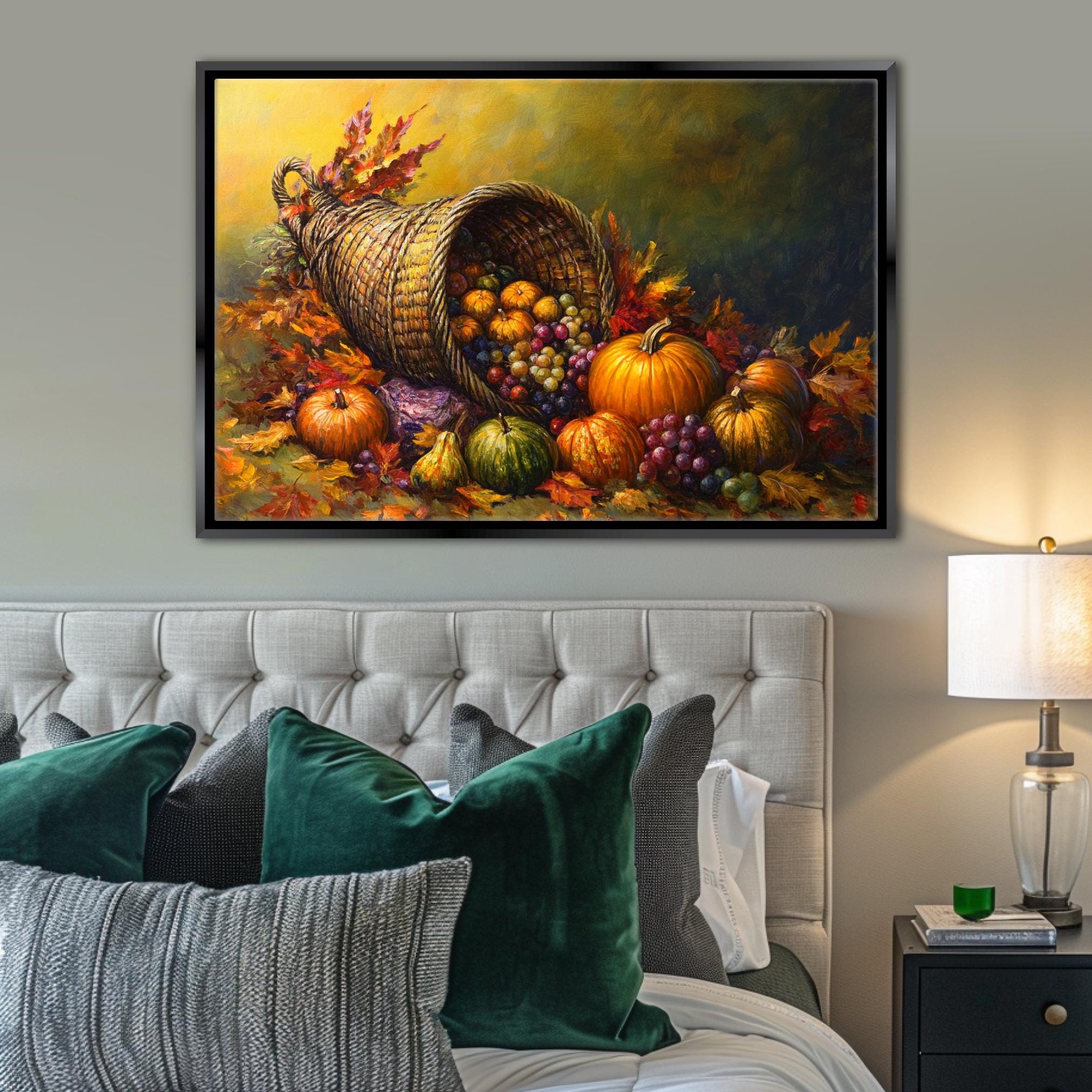 a large painting of a basket overflowing with various fruits, including pumpkins, grapes, and apples, set against a backdrop of autumn leaves. The painting is displayed on a wall above a bed with green pillows and a nightstand with a lamp.