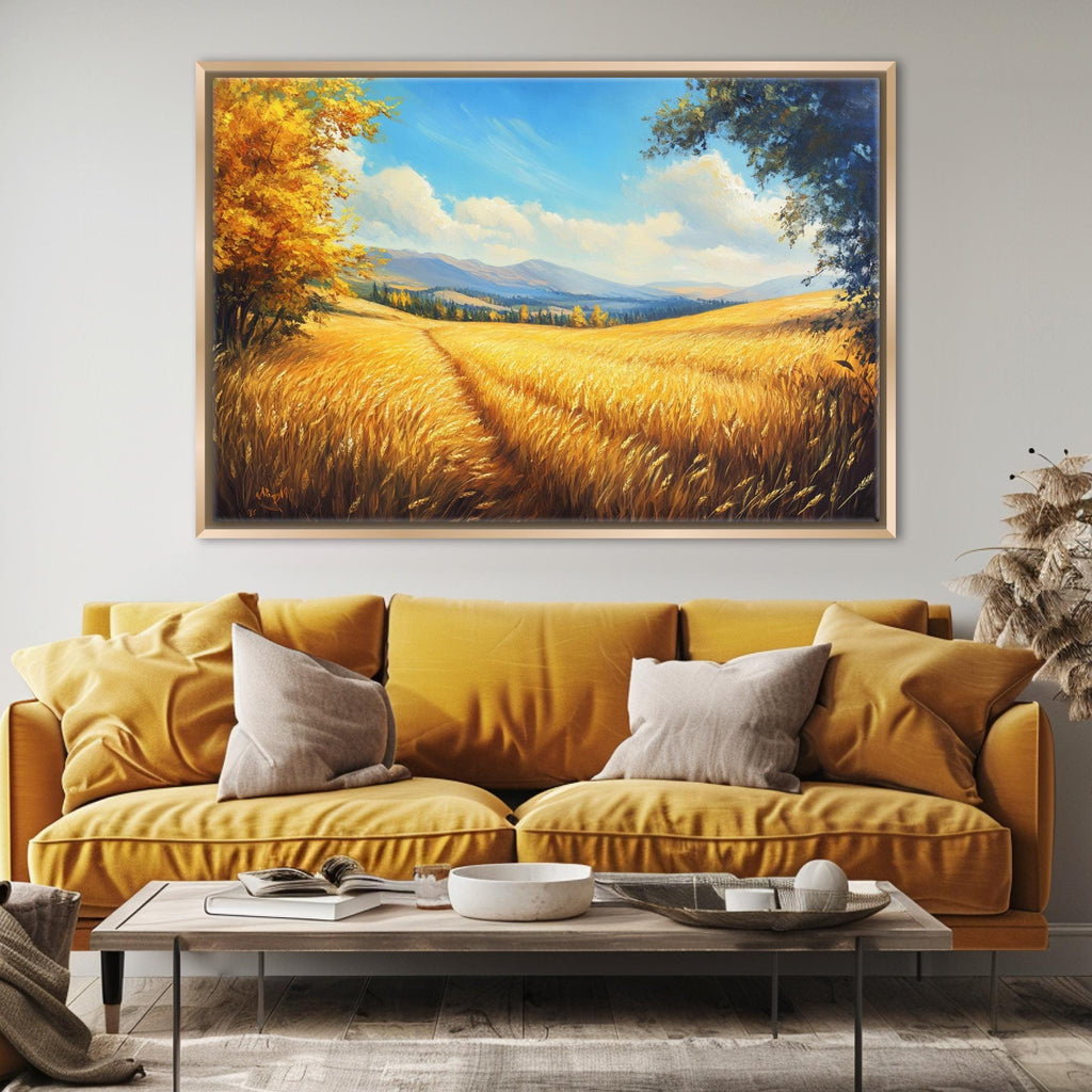 a large painting of a field with golden wheat, hanging on a wall above a yellow sofa with two pillows.