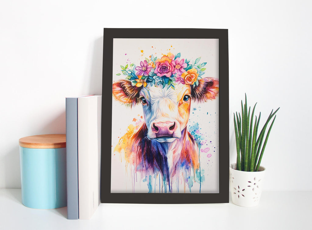 a framed painting of a cow with a colorful floral crown on its head, placed on a shelf next to a potted plant and some books.
