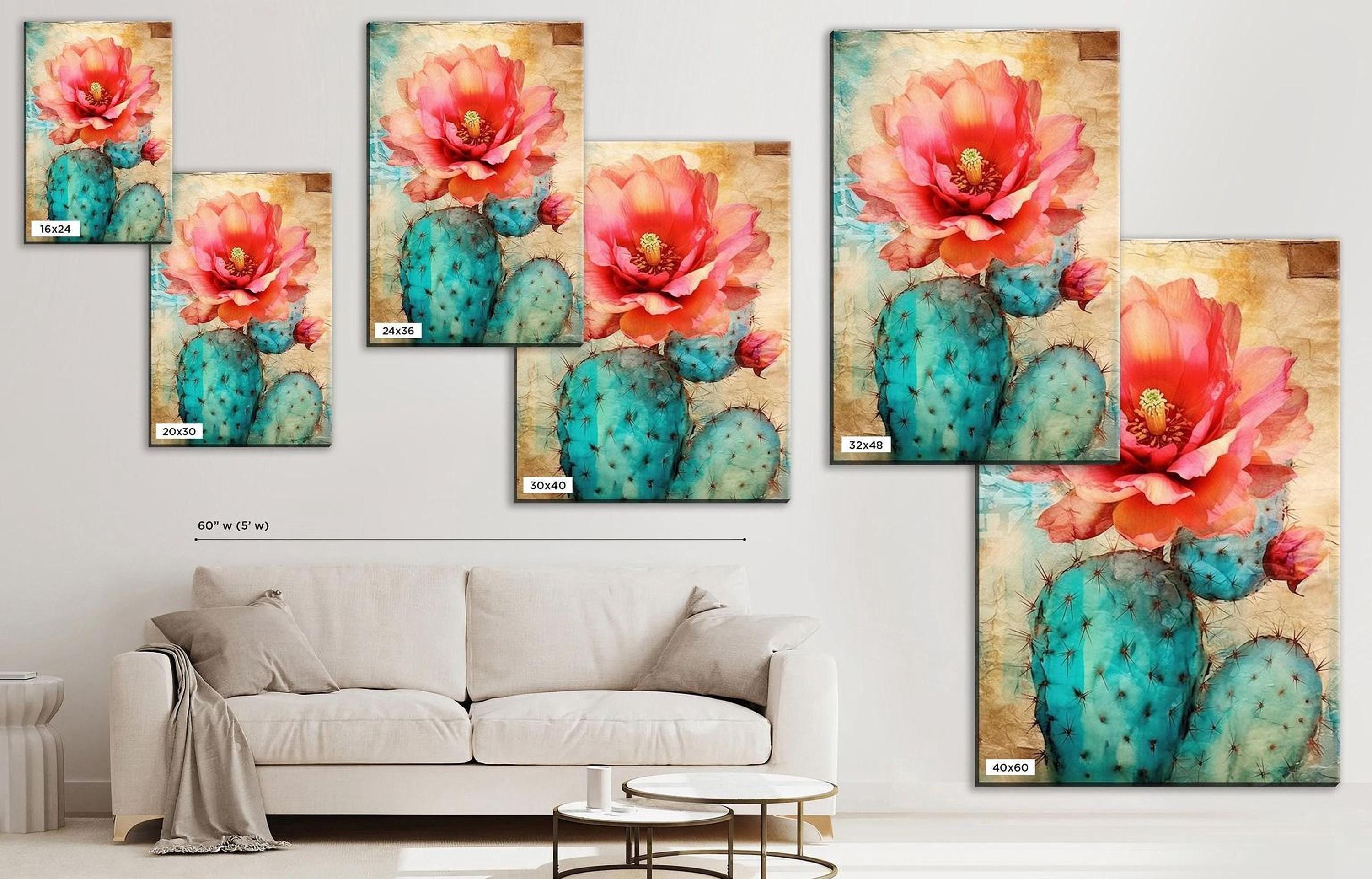The image is a living room with a white sofa and a coffee table. There are multiple framed paintings of cacti and flowers on the wall, including a large painting of a cactus with a pink flower. The paintings are arranged in a grid-like pattern, creating a visually appealing display.