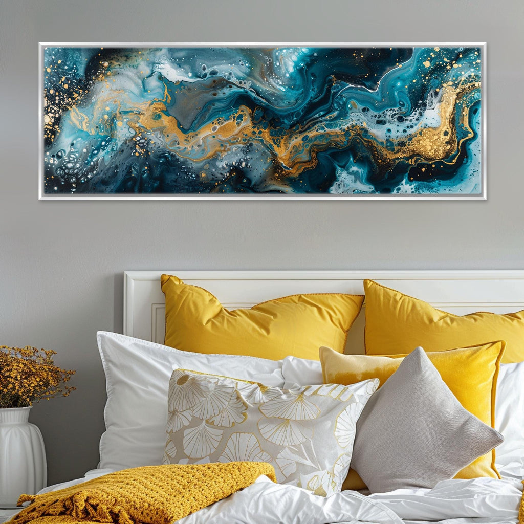 a bed with yellow pillows and a painting on the wall