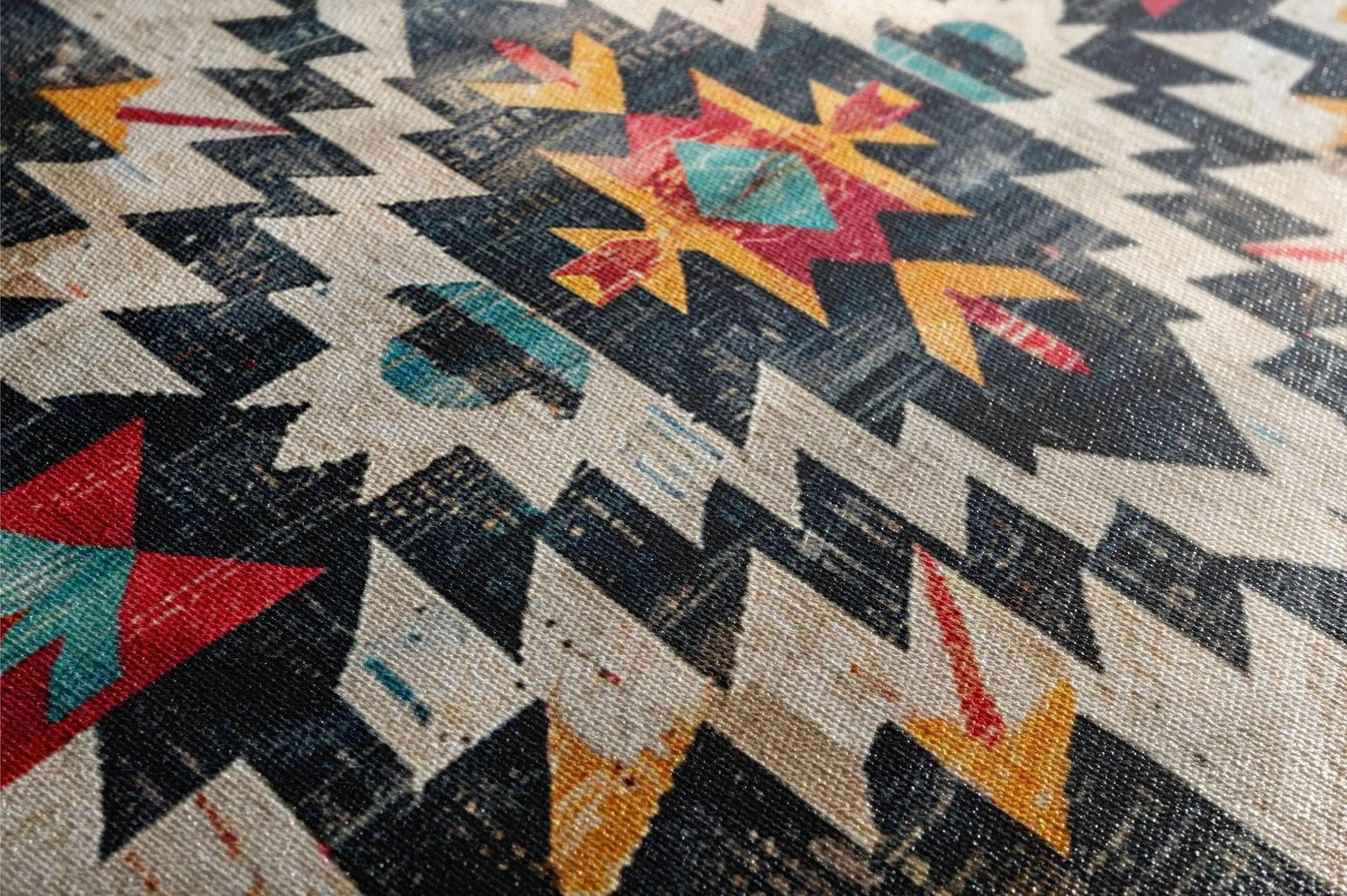 a close-up view of a colorful, geometric pattern on a fabric or textile. The pattern consists of various shapes and colors, including triangles, rectangles, and diamonds, creating a visually striking and intricate design.