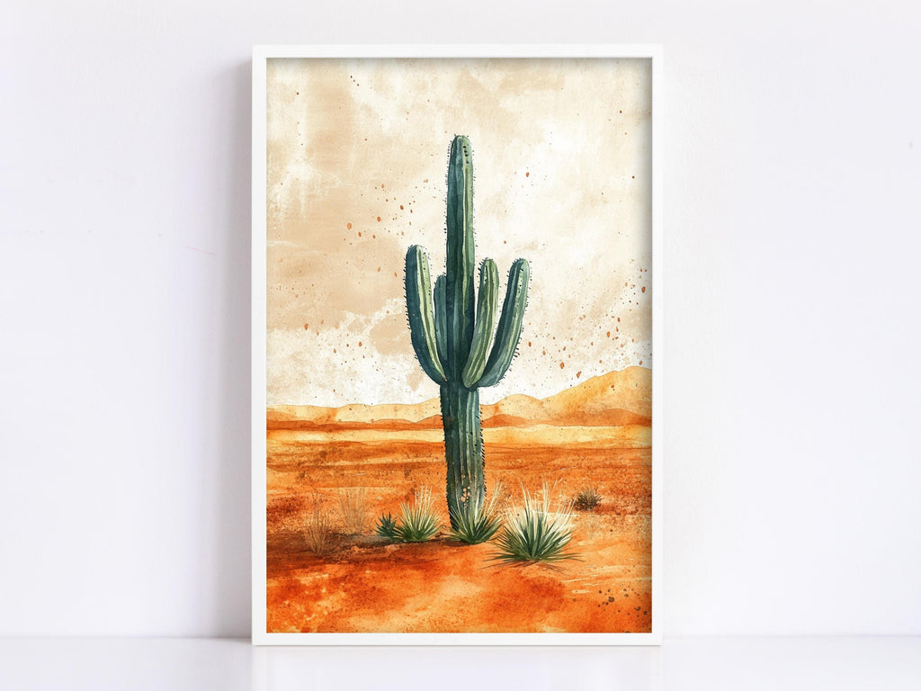 A framed painting depicting a tall cactus standing in a desert landscape with orange and brown hues.