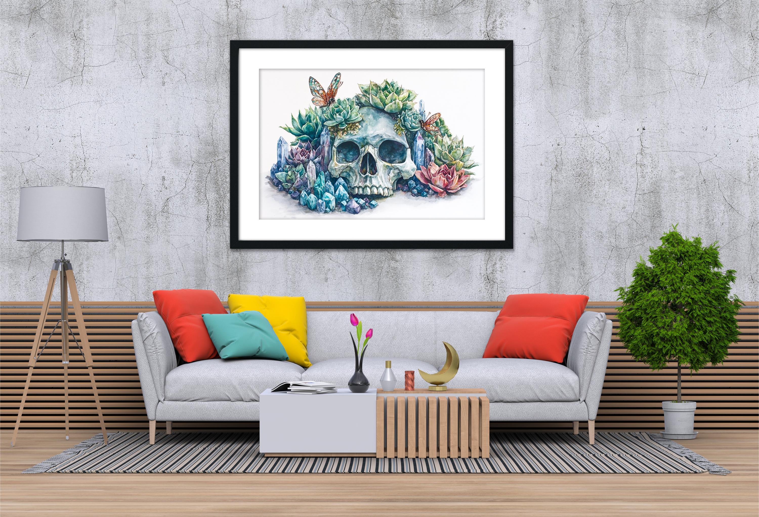 a modern living room with a gray sofa, a wooden coffee table, and a framed artwork of a skull surrounded by colorful flowers and butterflies.