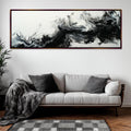 a living room with a couch and a painting on the wall