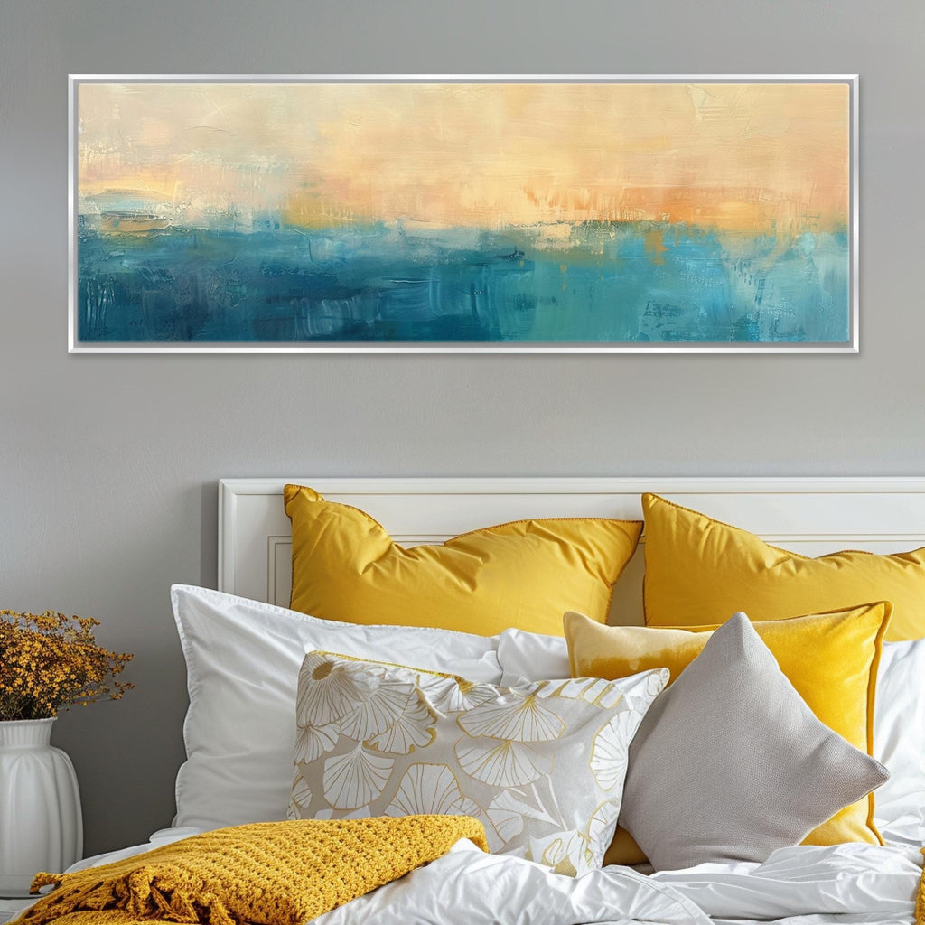 a bed with yellow and white pillows and a painting on the wall